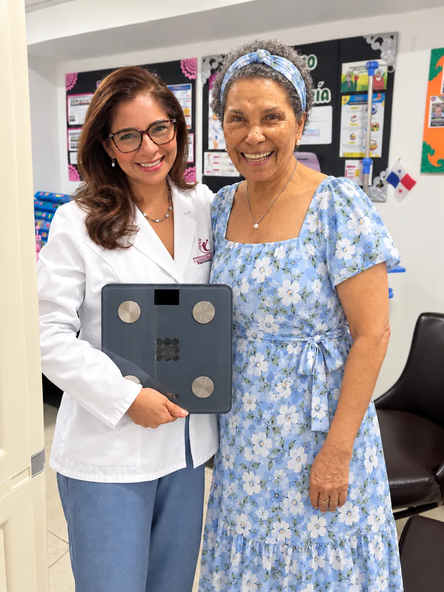 Control de peso: profesional de salud con una residente sobre una báscula.